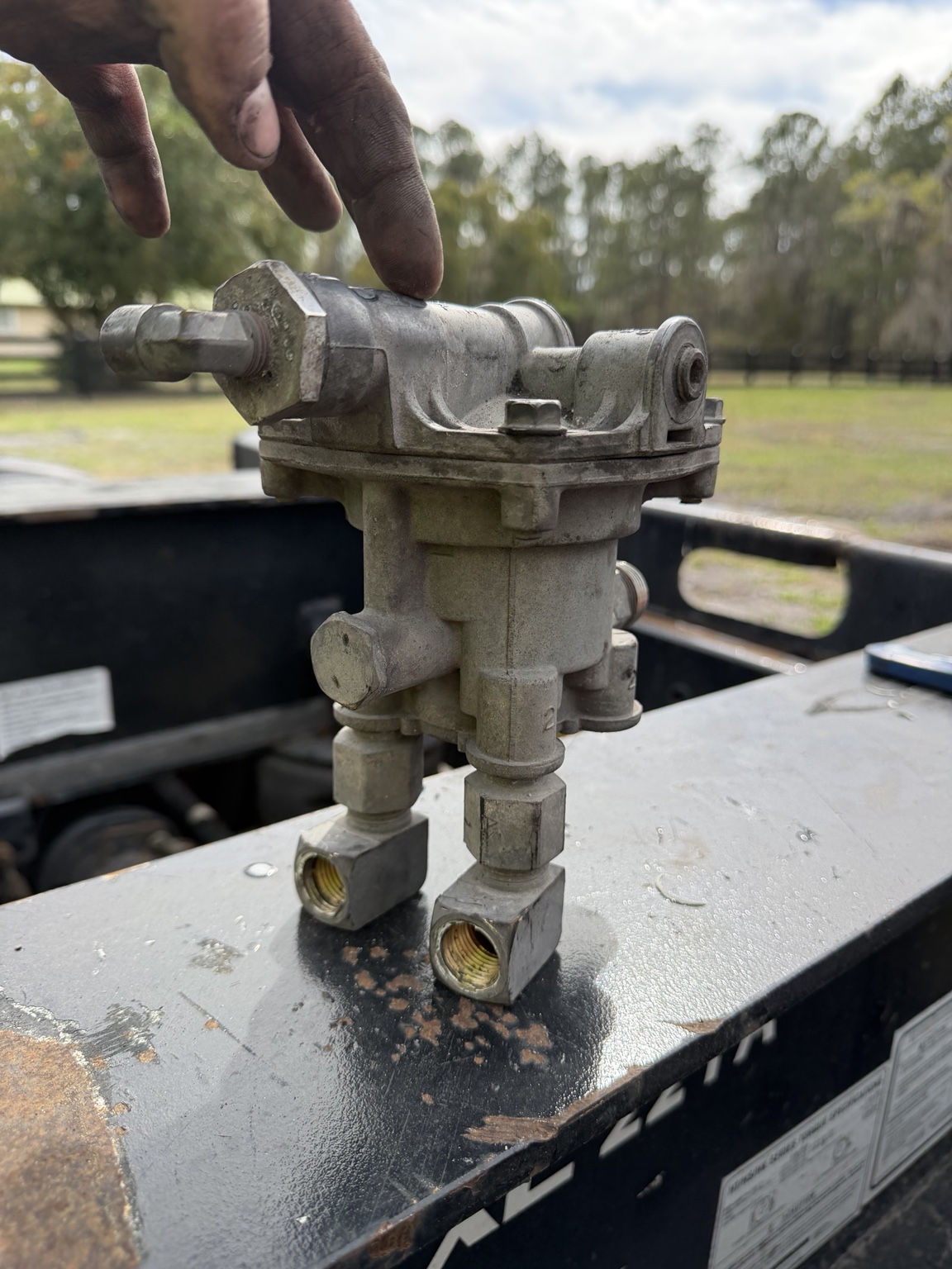 Old trailer air-brake relay valve removed before replacement at SEG